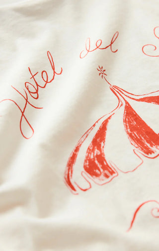 Close-up of a textured fabric with red 'Hotel del' text and decorative elements.
