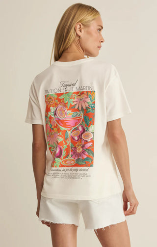 Woman wearing a white t-shirt with a colorful graphic design on a beige background