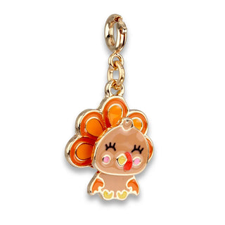 A gold-plated metal charm featuring a cute cartoon turkey with orange feathers, a peach-colored body, and small pink, yellow, and red accents, shown on a plain white background.