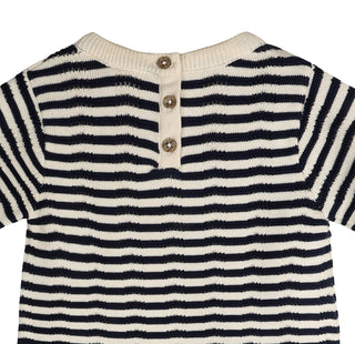 Navy and white striped shirt with button details on a white background
