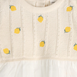 Knitted dress with pineapple patterns on a textured background