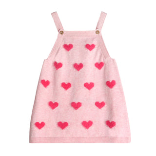 Pink dress with red heart patterns on a white background