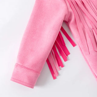 Close-up of a pink fabric with fringe on a white background