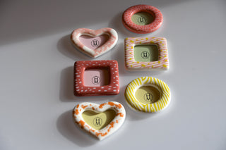Set of colorful ceramic frames on a light gray background