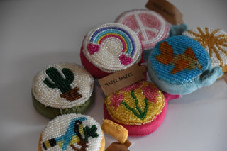 Colorful beaded items with various designs on a white background