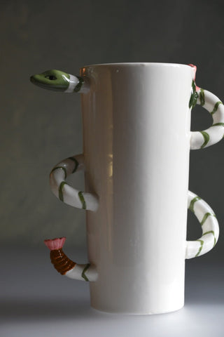White ceramic vase with snake-like handles on a gray background