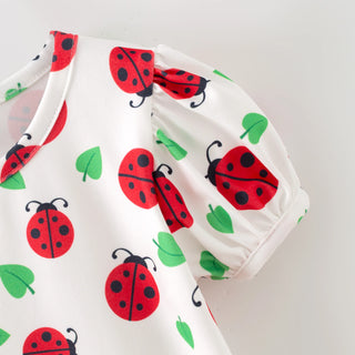 Baby outfit with ladybug pattern on a white background