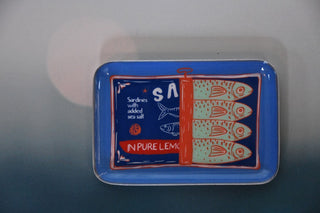 Blue tray with fish design and text on a gray background