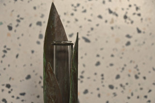 Knife blade with a metallic clip on a speckled surface