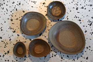 Set of ceramic plates on a speckled surface