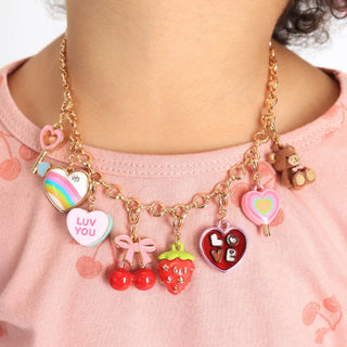 Necklace with colorful charms worn by a person on a pink shirt
