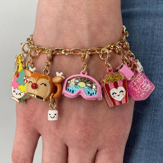 Bracelet with colorful charms on a wrist against a neutral background