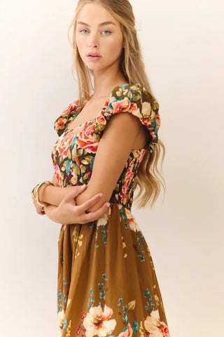 Woman wearing a floral dress with a plain background