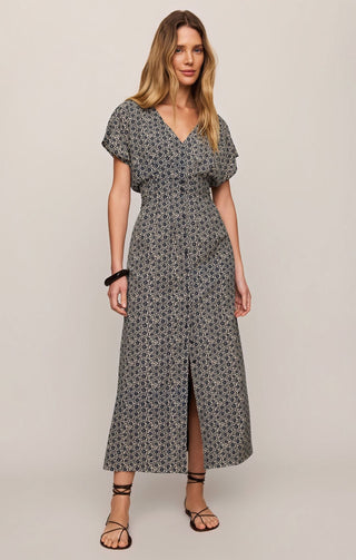 Woman wearing a patterned dress on a plain background