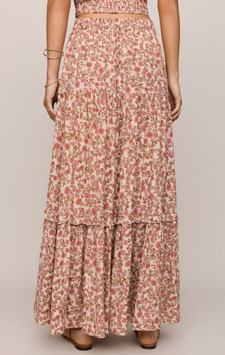 Floral tiered skirt worn by a person on a plain background