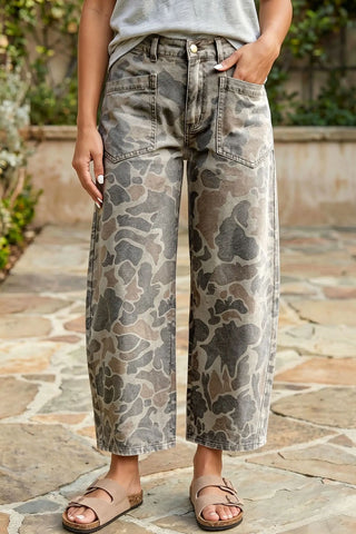 Person wearing camouflage wide-leg pants on a stone path.