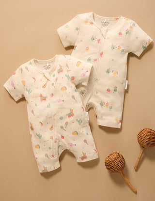 Two baby rompers with colorful patterns on a beige background