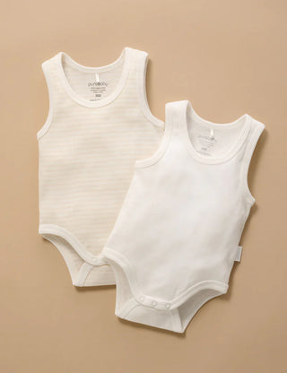 Two white sleeveless baby bodysuits on a beige background