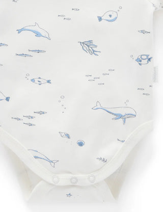 Baby onesie with blue whale and fish pattern on a white background