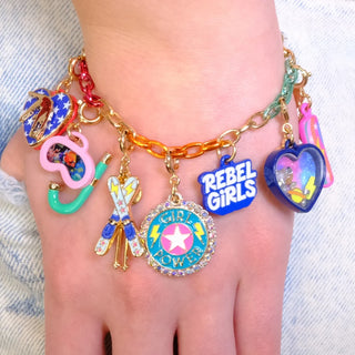 Colorful charm bracelet on a wrist with 'REBEL GIRLS' and other decorative charms.