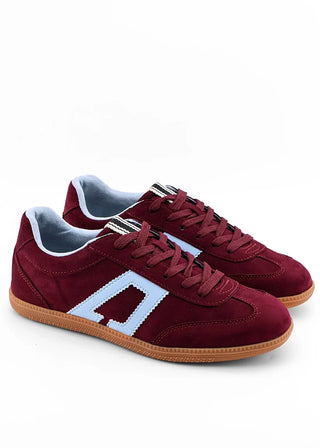 A pair of low-top suede sneakers in burgundy with a light blue side stripe, light blue lining, and gum soles, shown on a white background.