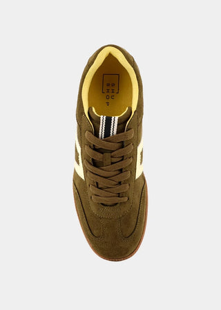 A single low-top sneaker shown from a top-down view on a light gray background. The shoe is primarily olive brown suede with a bright yellow interior lining, yellow side stripes, and a brown rubber outsole.