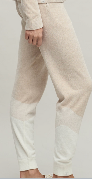 Beige pants with a color-block design on a plain background