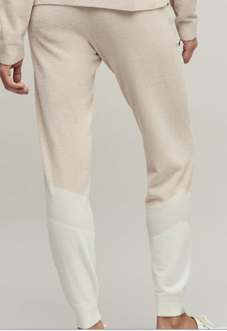 Beige and white pants on a plain background