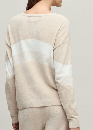 Beige sweater with a gradient design on a plain background