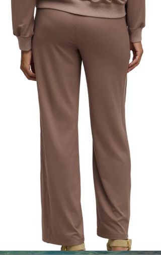Brown pants worn by a person on a white background