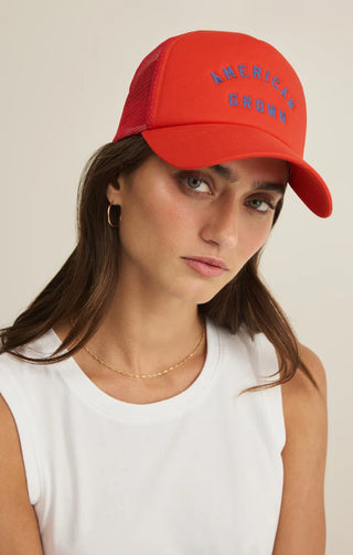 Woman wearing a red cap with text on a plain background
