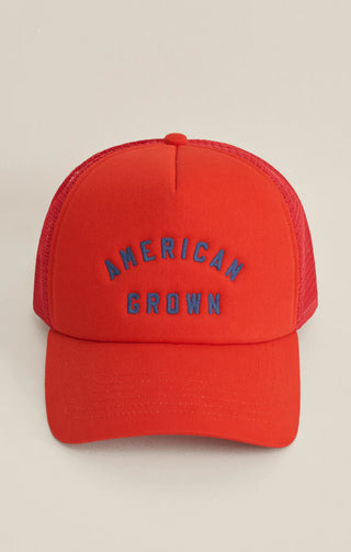 Red cap with 'American Grown' text on a beige background