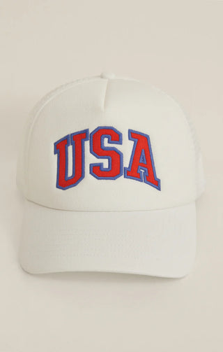 White cap with 'USA' in red and blue on a beige background