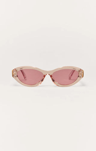 Sunglasses with a cat-eye design and pink lenses on a white background