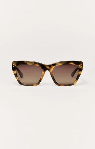 Sunglasses with tortoiseshell frame and brown lenses on a white background