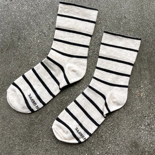 Pair of gray socks with black stripes on a gray surface