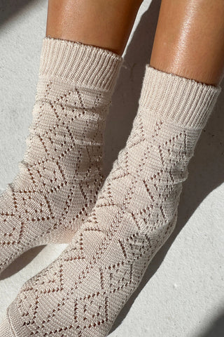 Close-up of beige patterned socks on a light background