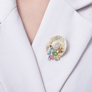 Colorful brooch with gemstones on a white blazer