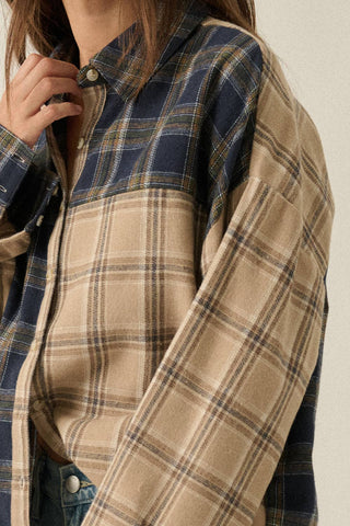 Close-up of a person wearing a plaid shirt with a neutral background