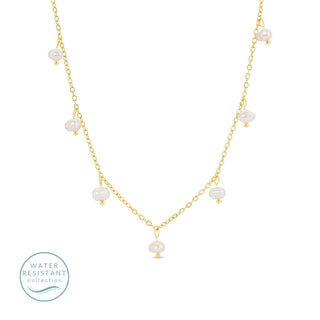 Gold necklace with pearls on a white background, featuring a 'Water Resistant' collection label.
