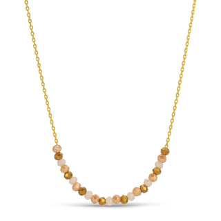 Necklace with small beads on a gold chain against a white background