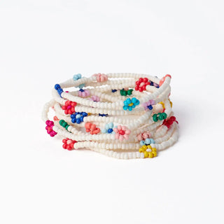 Stack of colorful beaded bracelets on a white background