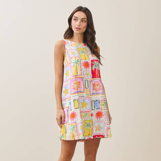 Woman wearing a colorful patterned dress on a plain background