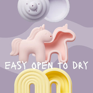 Pink unicorn-shaped silicone squirt toy with text 'Easy open to dry' on a purple background