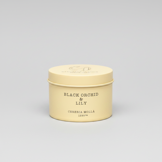 Beige candle tin labeled 'Black Orchid & Lily' by Cereria Molla on a white background