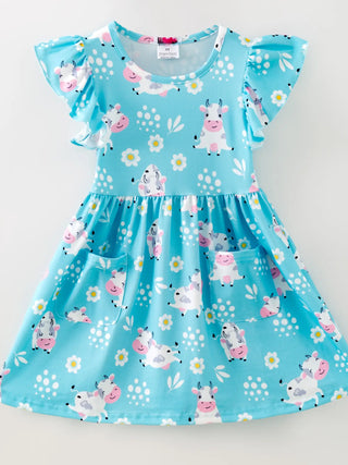 Children's dress with farm animal print on a light blue background