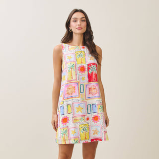 Woman wearing a colorful patterned dress against a plain background