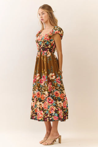 Woman wearing a floral dress on a plain background