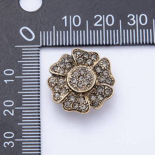 Decorative brooch with rhinestones on a white background with a ruler for scale.
