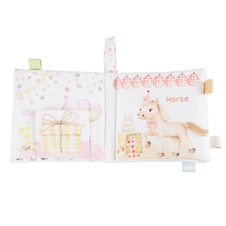 Children's book with illustrations of a horse and gift box on a white background